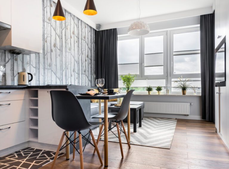A finished ADU kitchen and dining area with large windows