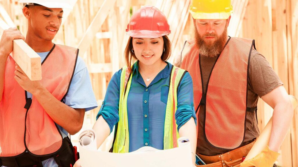 Construction crew reviewing plans on a job site